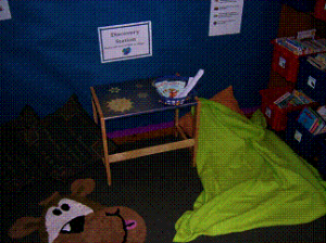 The blanket and pillow in the reading corner that doubled as a bed for anyone who hadn't been able to sleep the night before.